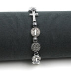 Detalle de la pulsera de hematita con medalla de San Benito y cruz