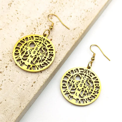 Pendientes de San Benito: Luz y Protección en Acero Dorado