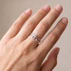 Anillo cruz con circonias plateado puesto en la mano