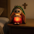 Peluche de la Virgen de Guadalupe encendido como luz nocturna en la mesita de noche